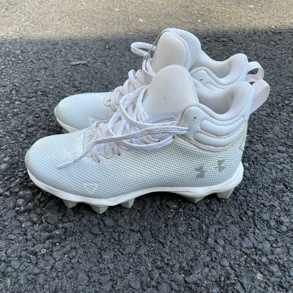 Kids under Armour football cleats worn one season. Size 2y.